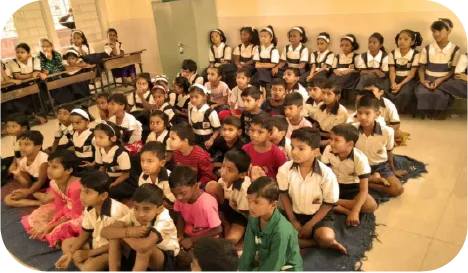 Speaker presenting digital safety training to students in a school hall